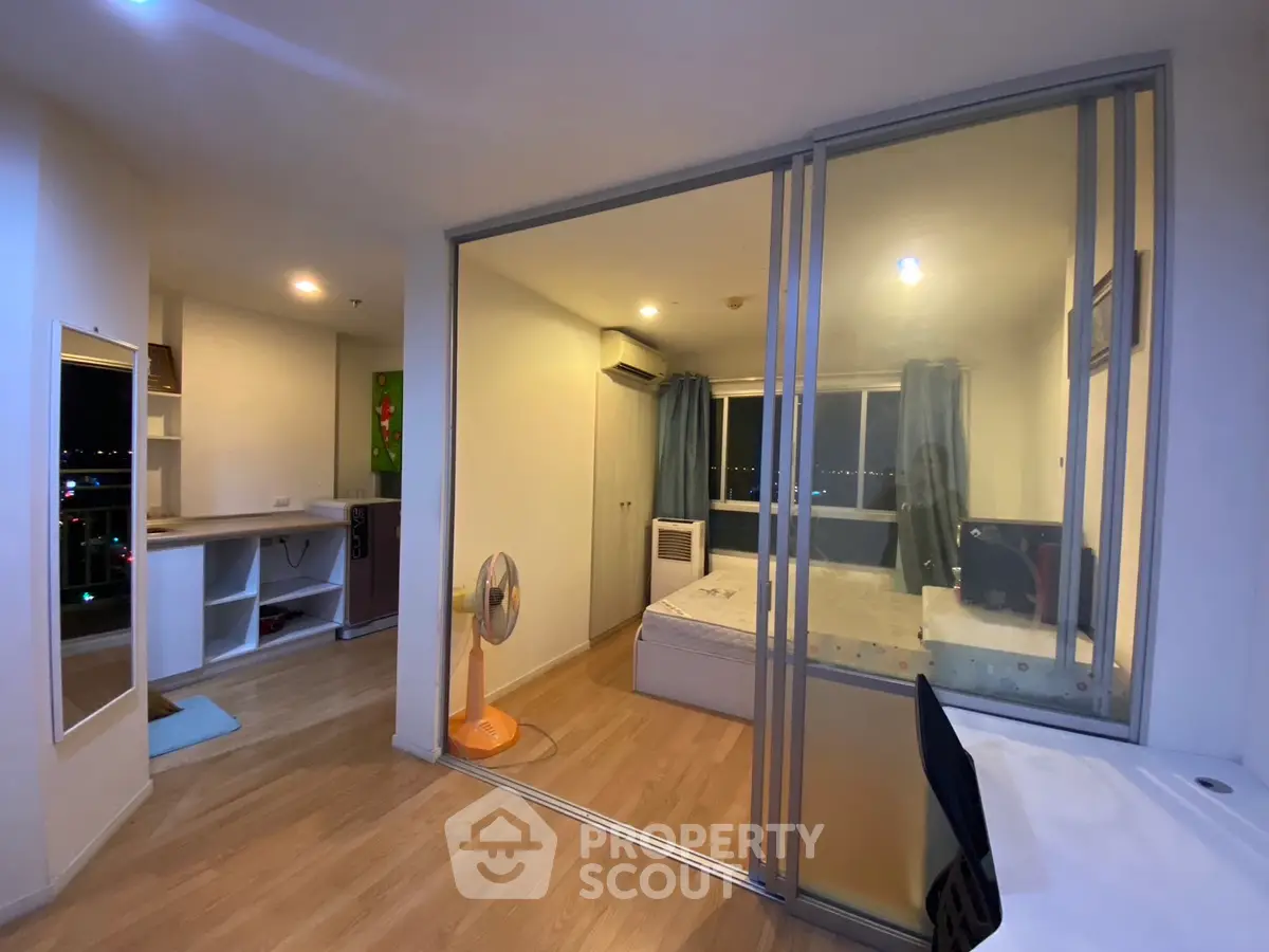 Modern studio apartment with glass partition and city view
