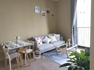 Charming living room with cozy sofa, dining set, and balcony view