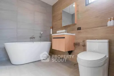 Modern bathroom with sleek design featuring a freestanding bathtub and elegant fixtures.