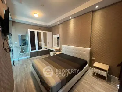 Spacious modern bedroom with elegant decor and ample storage space