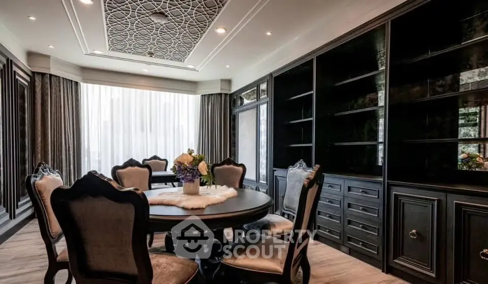 Luxurious dining room with elegant black furniture and intricate ceiling design