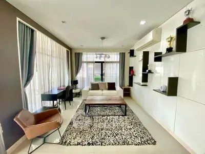 Modern living room with stylish decor and large windows offering natural light.