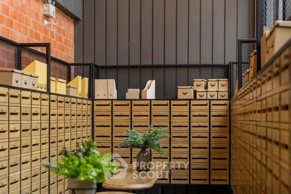 Stylish industrial-style mailroom with organized mailboxes and modern decor