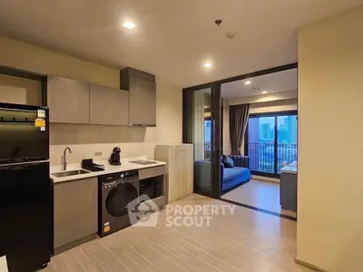 Modern open-plan kitchen and living room with city view balcony
