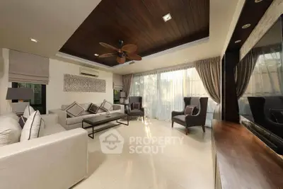Luxurious living room with elegant decor and large windows offering natural light.