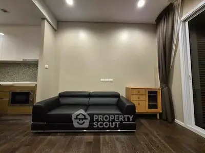 Modern living room with sleek black sofa and stylish wooden cabinet