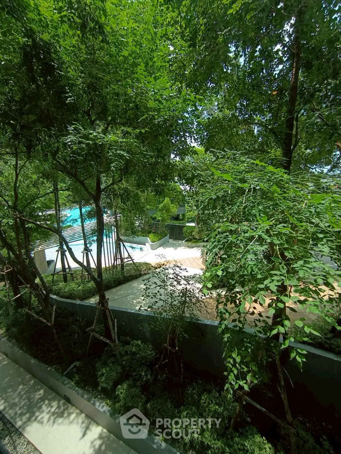 Lush garden view with pool in a serene residential complex