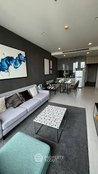 Modern living room with stylish decor and open kitchen layout in a contemporary apartment.