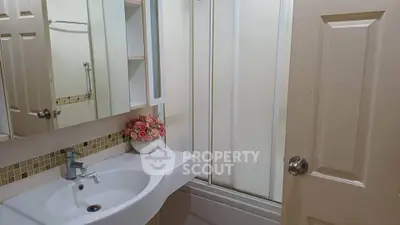 Charming bathroom with modern sink and floral decor, perfect for a cozy home ambiance.