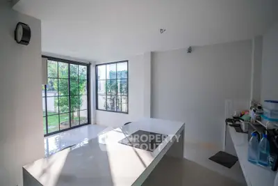 Modern kitchen with sleek design and large windows overlooking garden