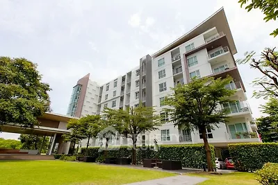 Modern apartment building with lush greenery and spacious balconies