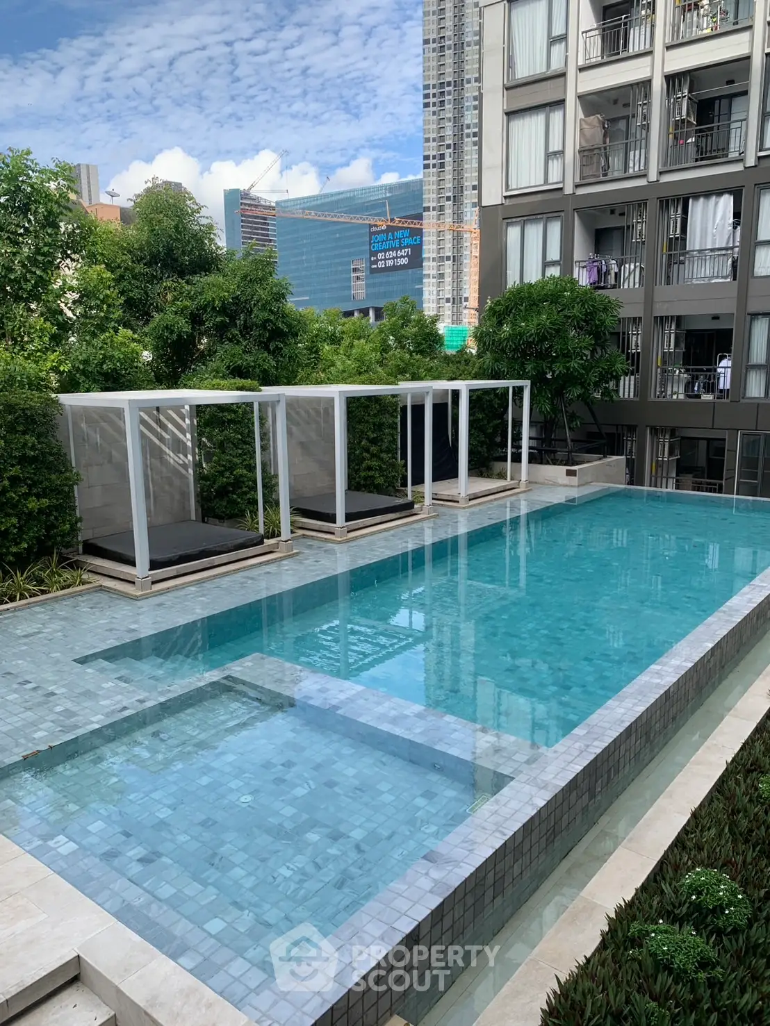 Luxurious condominium with stunning outdoor pool and modern architecture, perfect for urban living.