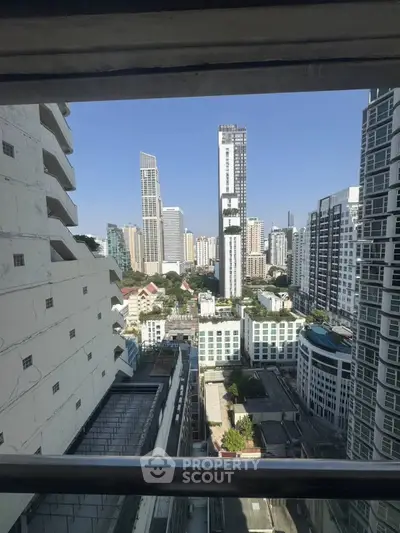 Stunning cityscape view from high-rise building window showcasing modern urban skyline.