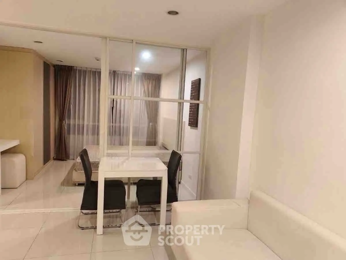 Modern minimalist living room with white sofa and dining area