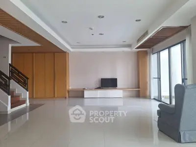 Spacious modern living room with sleek design and large windows for natural light.