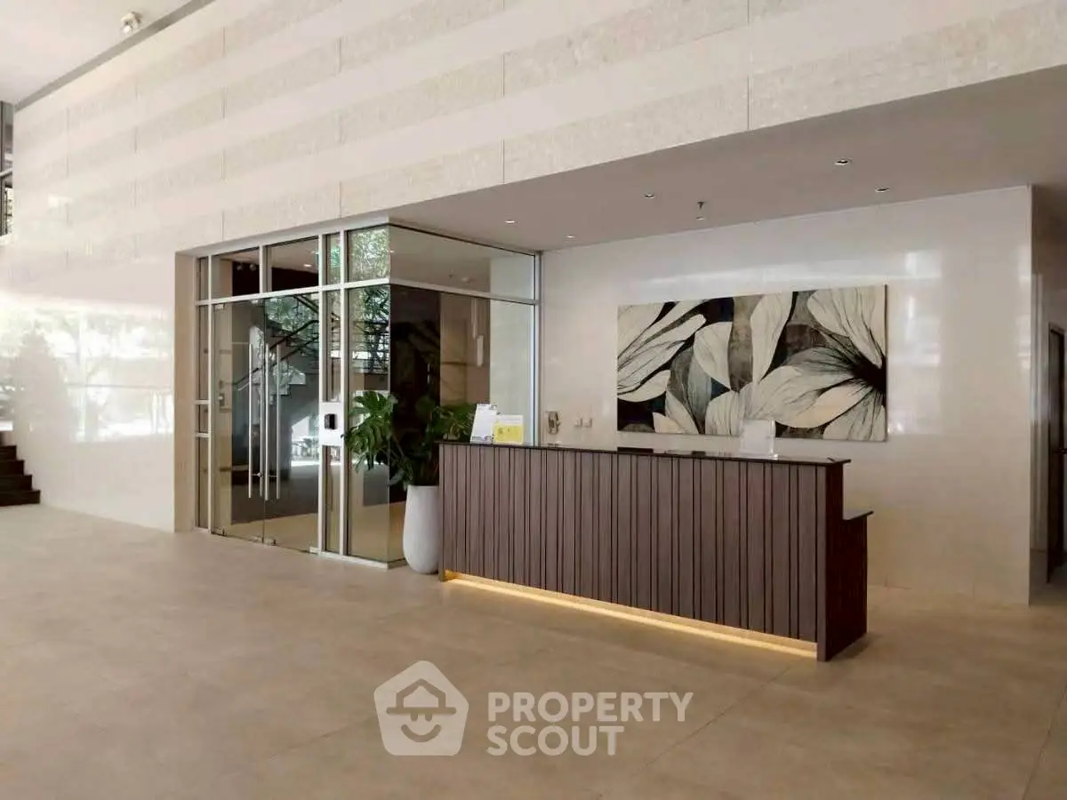 Elegant building entrance with modern reception desk and stylish decor