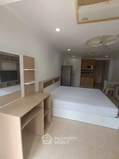 Spacious studio apartment with modern furnishings and open kitchen layout