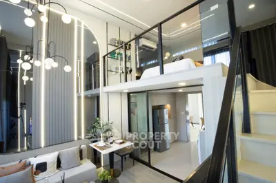Modern loft apartment with stylish mezzanine bedroom and open living area, featuring sleek lighting and contemporary decor.