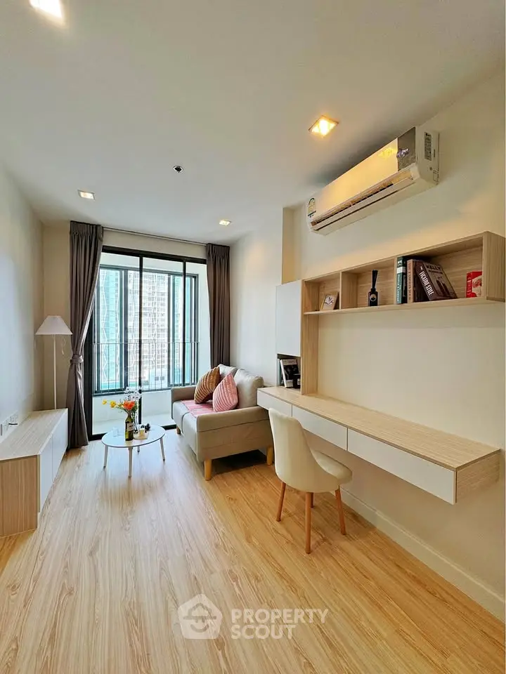 Modern living room with stylish decor and city view, featuring a cozy sofa and sleek wooden flooring.