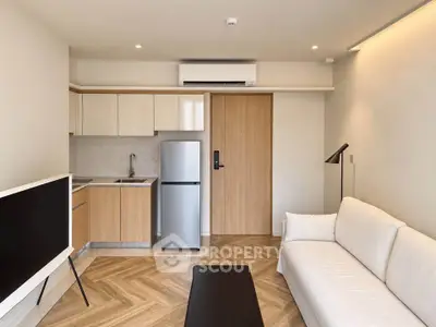 Modern living room with compact kitchen and stylish decor