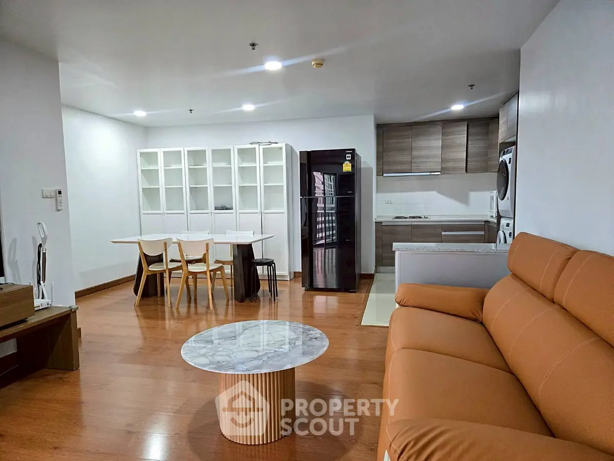 Modern open-plan living room with stylish kitchen and cozy seating area