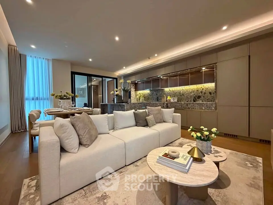 Luxurious modern living room with elegant decor and open kitchen layout, perfect for stylish urban living.