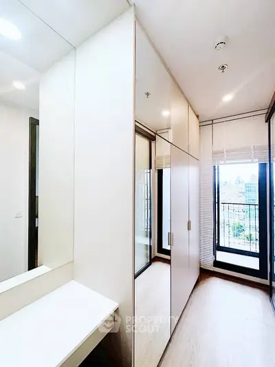 Modern bedroom with built-in wardrobe and city view balcony