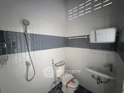 Modern bathroom with sleek shower and minimalist design in a contemporary home.