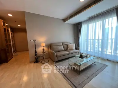 Spacious living room with modern decor and large window for natural light.