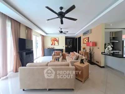 Spacious modern living room with elegant decor and open layout, featuring large windows and stylish furniture.