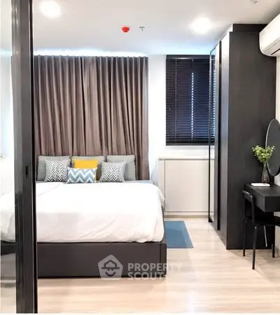 Modern bedroom with stylish decor, featuring a cozy bed, elegant curtains, and a sleek study area.
