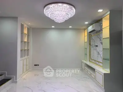 Luxurious living room with marble flooring and elegant chandelier
