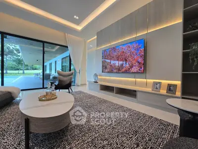 Luxurious modern living room with elegant decor and large glass doors opening to a scenic view.