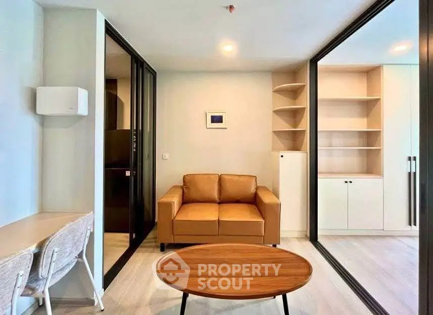 Modern living room with stylish furniture and built-in storage in a contemporary apartment.