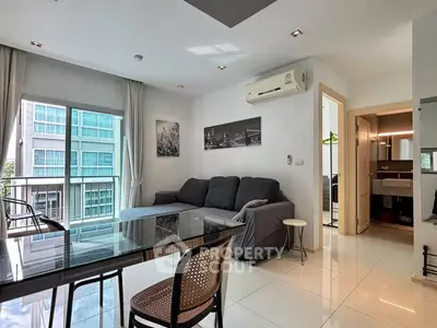 Modern living room with sleek furniture and large windows in a stylish apartment.