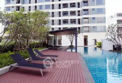 Luxurious apartment building with a stunning poolside area and modern amenities.