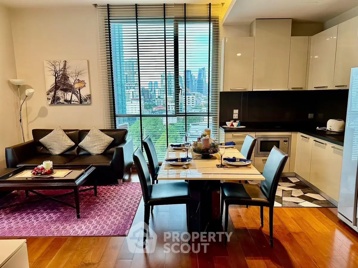 Modern open-plan living room and kitchen with city view, stylish decor, and dining area.