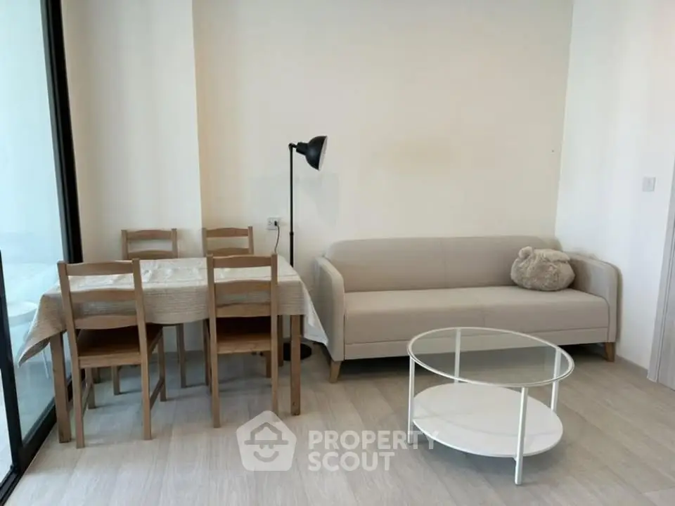 Modern living room with cozy sofa, dining table, and stylish decor in a bright apartment.