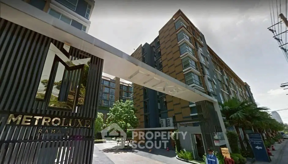 Modern condominium building with sleek design and lush landscaping at Metro Luxe Rama.