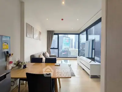 Modern living room with city view, sleek furniture, and natural light.