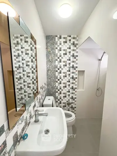 Modern bathroom with stylish tile design and compact layout