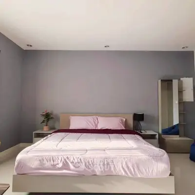 Spacious bedroom with modern decor and cozy ambiance
