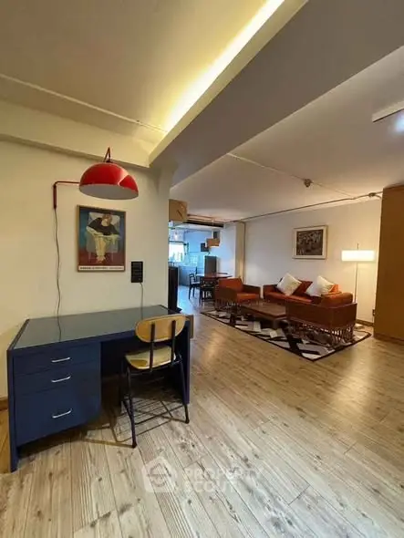 Spacious open-plan living room with stylish decor and wooden flooring