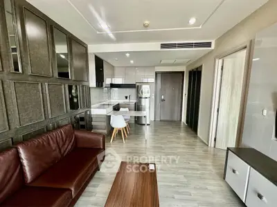 Modern open-plan living room with sleek kitchen and stylish decor