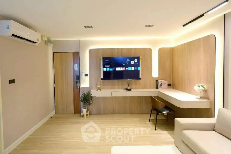 Modern living room with sleek TV setup and stylish wooden accents