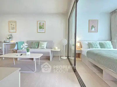 Modern open-plan living room and bedroom with stylish decor and natural light.