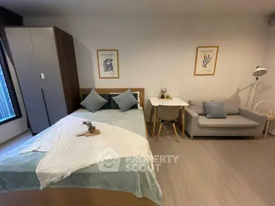 Cozy modern bedroom with stylish decor and compact living area