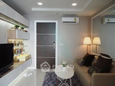 Modern living room with sleek furniture and ambient lighting, featuring a cozy sofa and stylish decor.