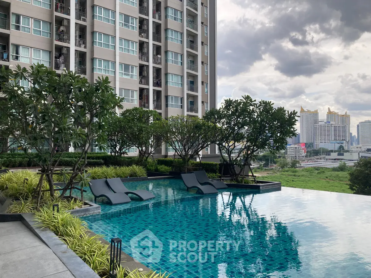 Luxurious condominium with stunning pool and lush greenery, offering a serene urban oasis with city views.
