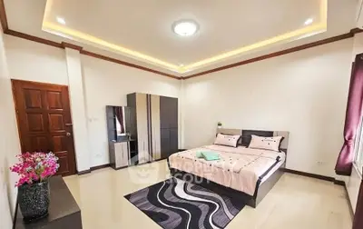 Spacious modern bedroom with elegant decor and ample natural light